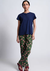 Ella – LaRosa Night Wears for Women – Cotton Summer Sets Collection | Larosawears | Shop Online – Front View.
Woman wearing a navy blue top and green pants with pink flamingo pattern on a white background